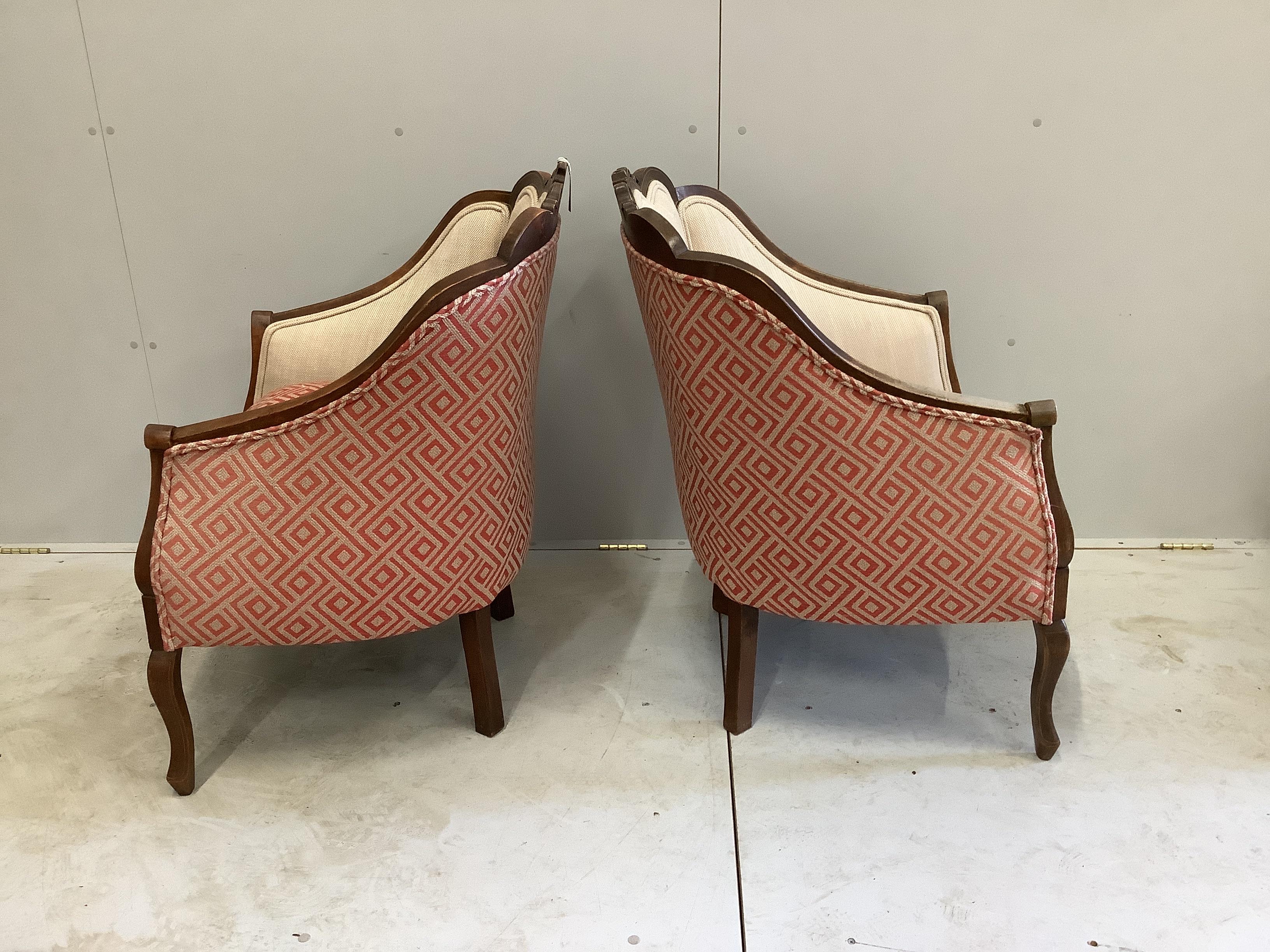 A pair of Edwardian inlaid mahogany upholstered armchairs, width 65cm, depth 66cm, height 90cm